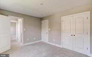 unfurnished bedroom with light carpet