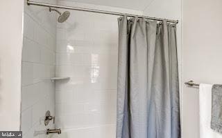 bathroom with shower / tub combo with curtain