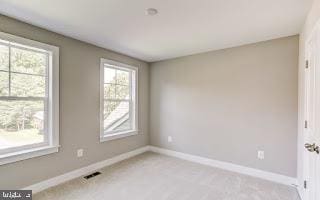 empty room featuring light carpet