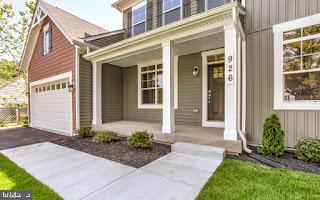 view of exterior entry featuring a garage and covered porch