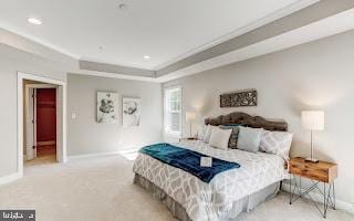 bedroom featuring a tray ceiling and light colored carpet