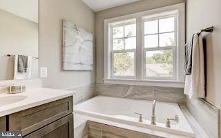 bathroom featuring vanity and a tub