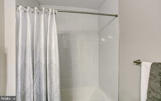 bathroom with shower / bathtub combination with curtain