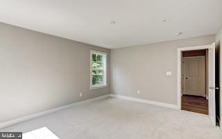 empty room featuring light carpet