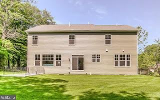 back of house with a lawn