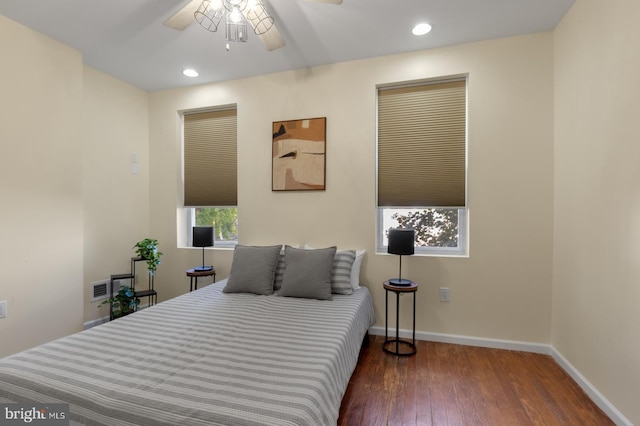 bedroom with ceiling fan and dark hardwood / wood-style flooring