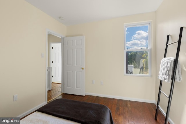 bedroom with dark wood-type flooring