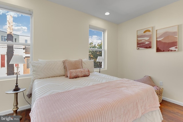 bedroom with dark hardwood / wood-style floors