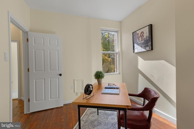 home office with dark hardwood / wood-style floors