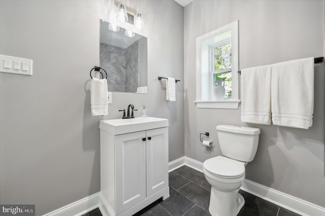 bathroom with tile flooring, vanity, and toilet