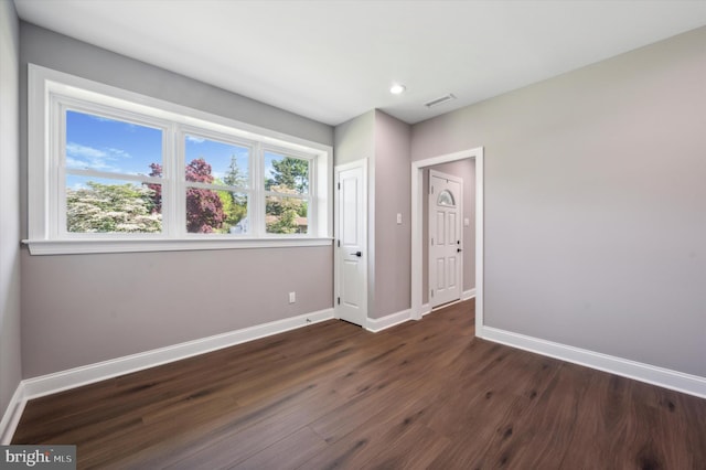 unfurnished room featuring dark hardwood / wood-style flooring