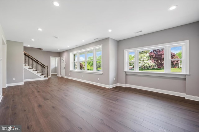 empty room with dark hardwood / wood-style flooring