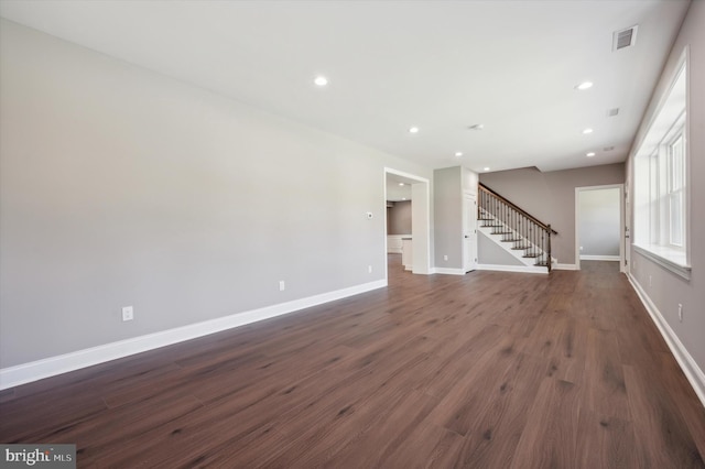 unfurnished living room with dark hardwood / wood-style floors