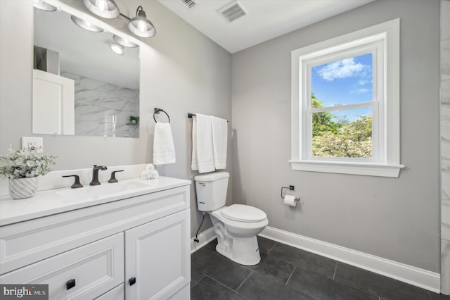 bathroom featuring an inviting chandelier, tile flooring, vanity, and toilet