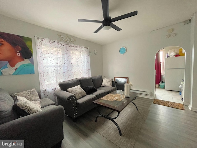 living room featuring hardwood / wood-style floors, ceiling fan, and a baseboard heating unit