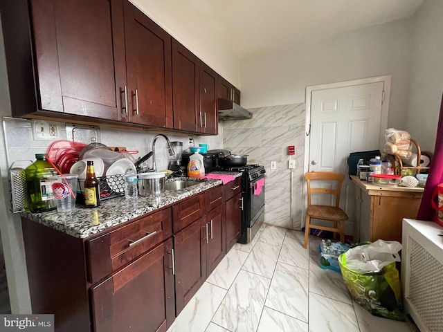 kitchen featuring stone counters, sink, light tile flooring, tasteful backsplash, and stainless steel gas stove