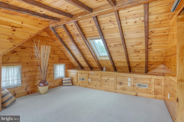 additional living space featuring carpet floors, visible vents, wood ceiling, wood walls, and vaulted ceiling with skylight