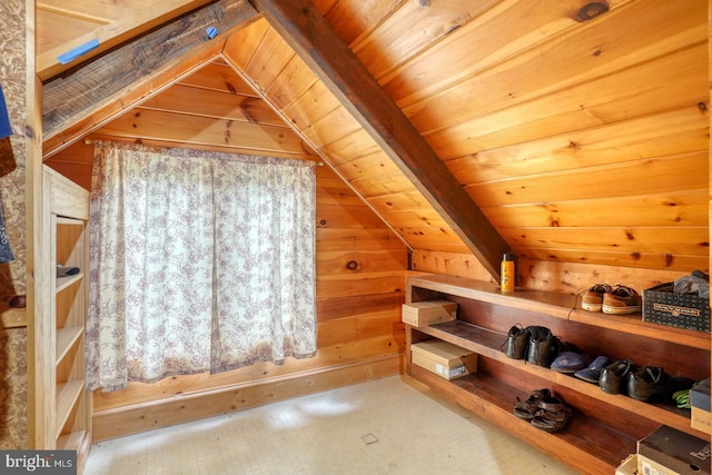 bonus room featuring lofted ceiling, wood ceiling, and wooden walls