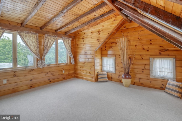 additional living space with vaulted ceiling with beams, carpet flooring, wood ceiling, and wooden walls