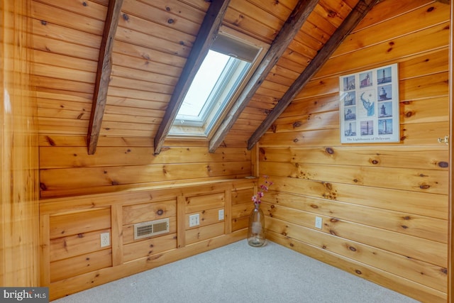 bonus room featuring vaulted ceiling with skylight, wood walls, and wood ceiling