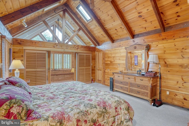 bedroom featuring lofted ceiling with skylight, wood ceiling, wooden walls, and carpet flooring