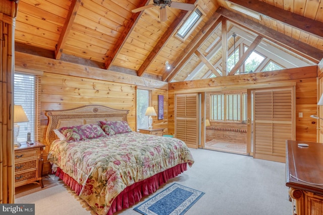 carpeted bedroom with vaulted ceiling with beams, wood walls, wooden ceiling, and access to exterior