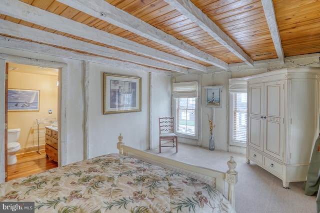 bedroom with wood ceiling, connected bathroom, beam ceiling, and light colored carpet