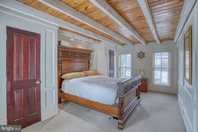 bedroom with light carpet, wooden ceiling, and beam ceiling