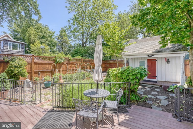 wooden deck with fence and an outdoor structure