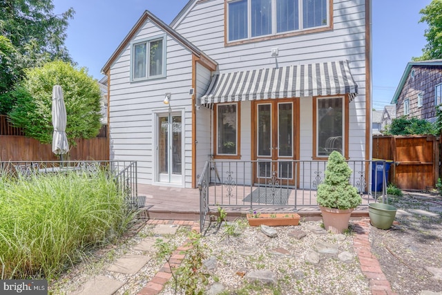 rear view of property featuring fence