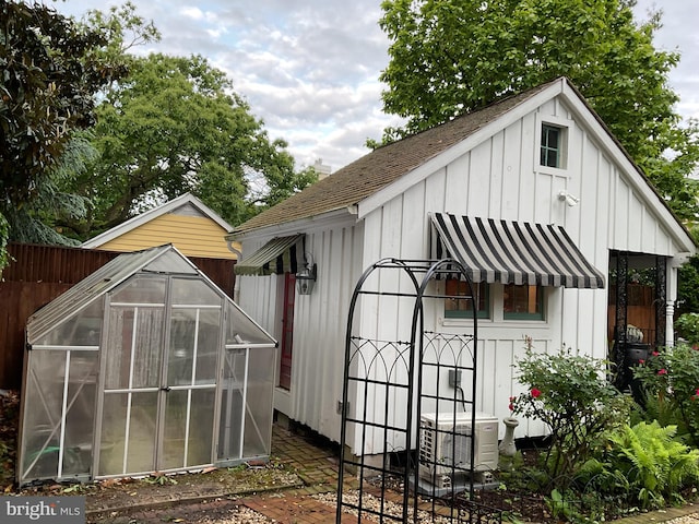 view of greenhouse featuring fence and central AC unit