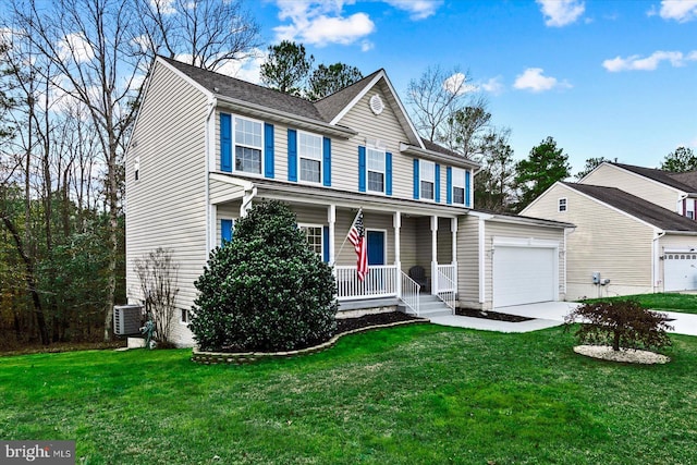 view of front of house with a front lawn, covered porch, and a garage