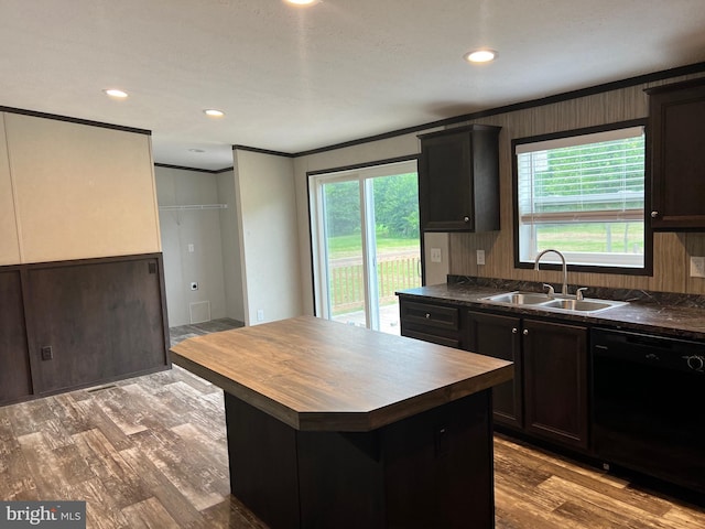 kitchen with crown molding, dishwasher, hardwood / wood-style flooring, sink, and a center island