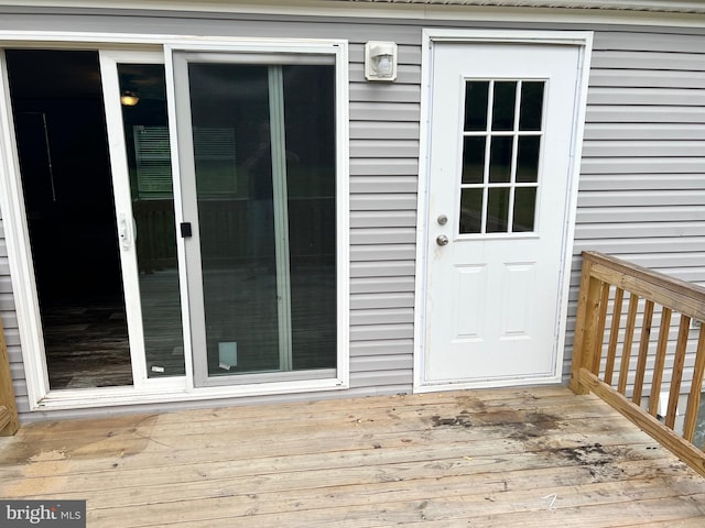 view of exterior entry with a deck