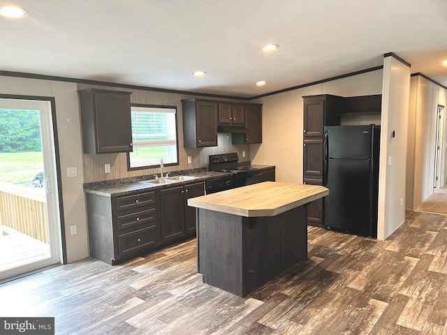 kitchen featuring a kitchen island, black refrigerator, sink, and hardwood / wood-style floors