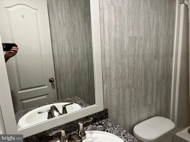 bathroom featuring vanity and toilet