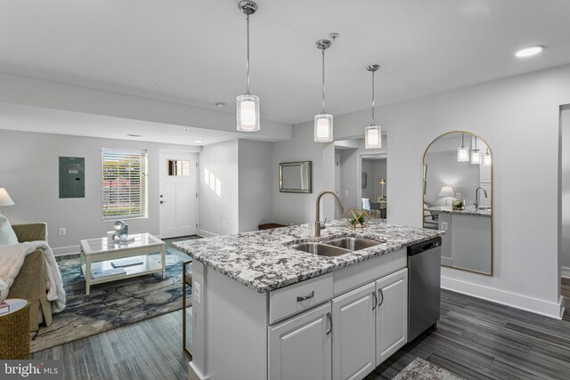 kitchen featuring sink, stainless steel dishwasher, decorative light fixtures, dark hardwood / wood-style floors, and a kitchen island with sink