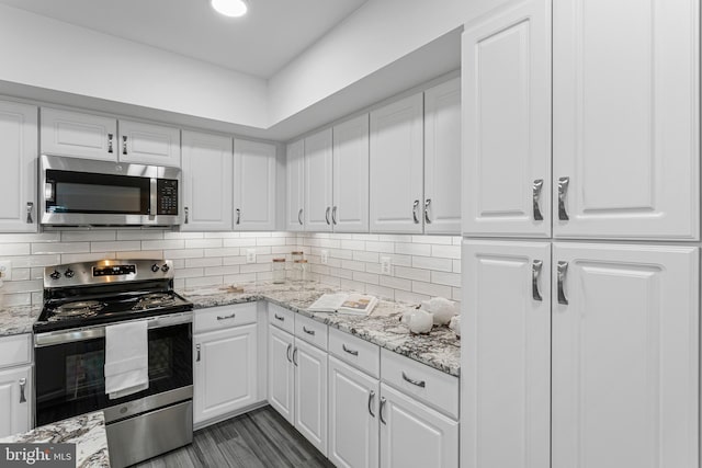 kitchen with light stone counters, tasteful backsplash, white cabinetry, and stainless steel appliances