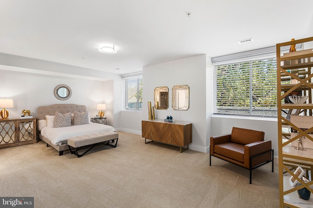 bedroom featuring light colored carpet