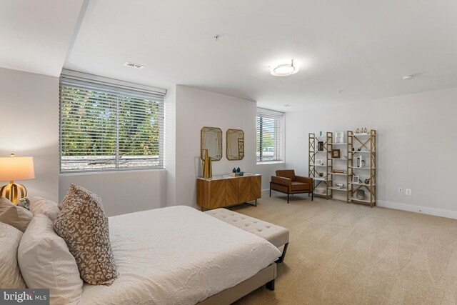 bedroom featuring light colored carpet