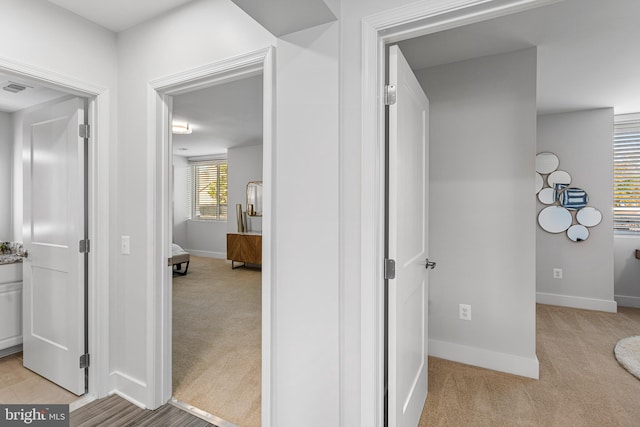 hallway with light carpet