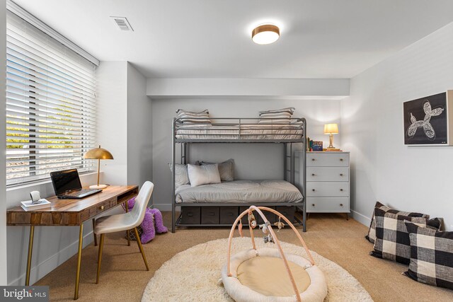 bedroom featuring light carpet