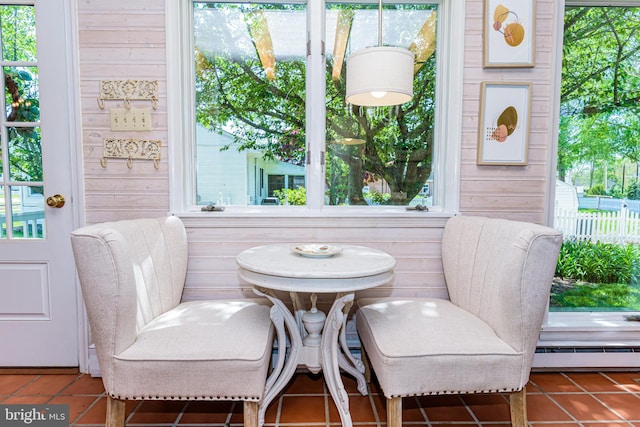 sitting room featuring a healthy amount of sunlight, a baseboard radiator, and tile floors