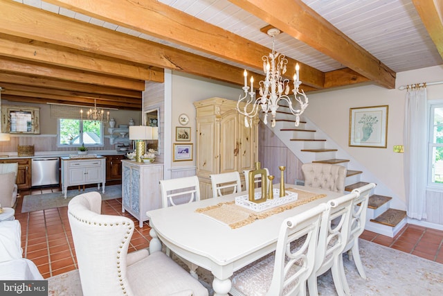 dining area with tile flooring, a notable chandelier, and beam ceiling