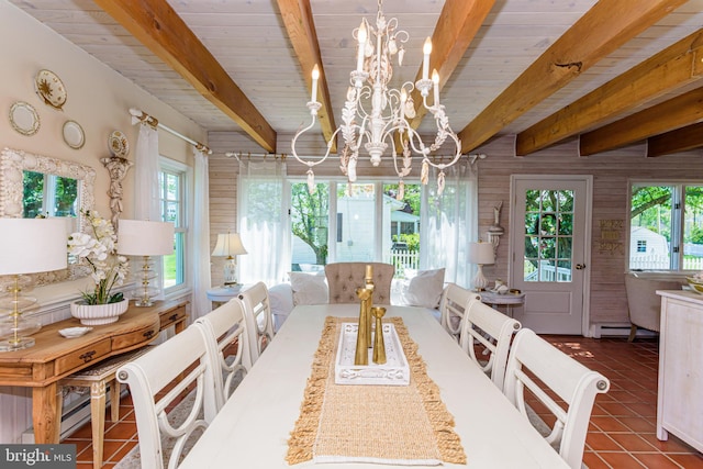 dining room with beam ceiling, a chandelier, a baseboard heating unit, and dark tile flooring