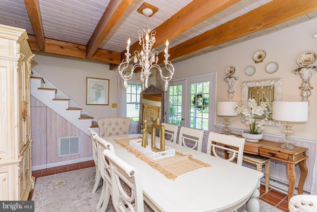 tiled dining room featuring beamed ceiling, french doors, a baseboard heating unit, wooden ceiling, and a chandelier