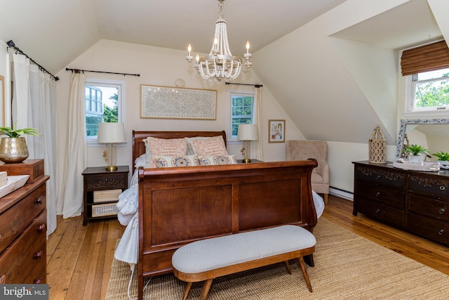 bedroom with wood-type flooring, a baseboard radiator, lofted ceiling, and a chandelier