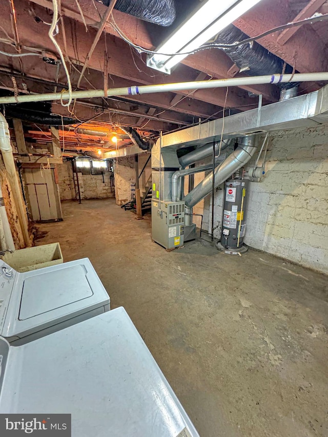 basement with gas water heater and washer / dryer