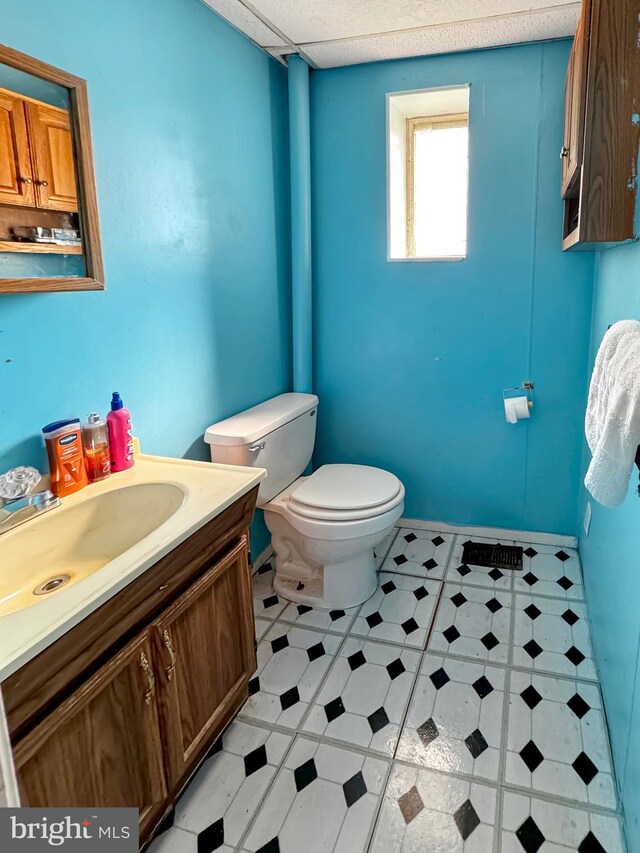 bathroom featuring tile floors, toilet, and vanity