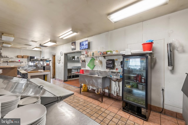 miscellaneous room with wine cooler and light tile flooring